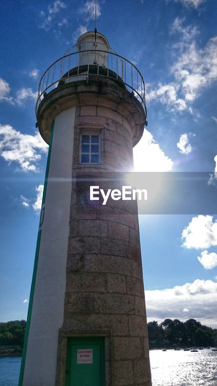 Low angle view of lighthouse against sky on sunny day at benodet