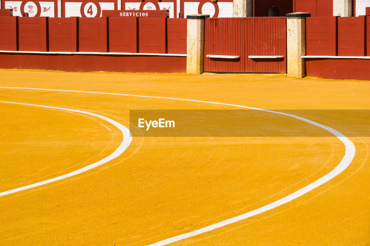 HIGH ANGLE VIEW OF BASKETBALL HOOP AGAINST YELLOW WALL