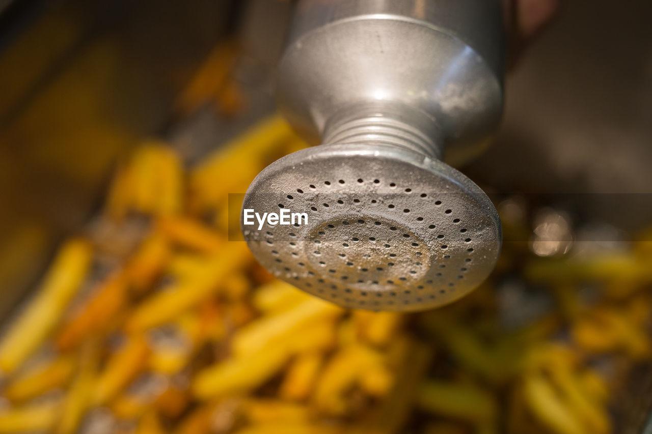 HIGH ANGLE VIEW OF WATER FLOWING FROM METAL