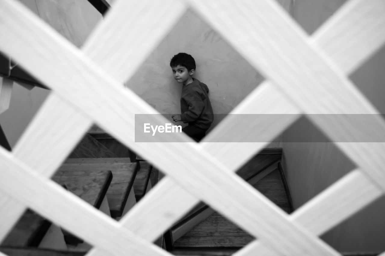 High angle portrait of boy standing on staircase