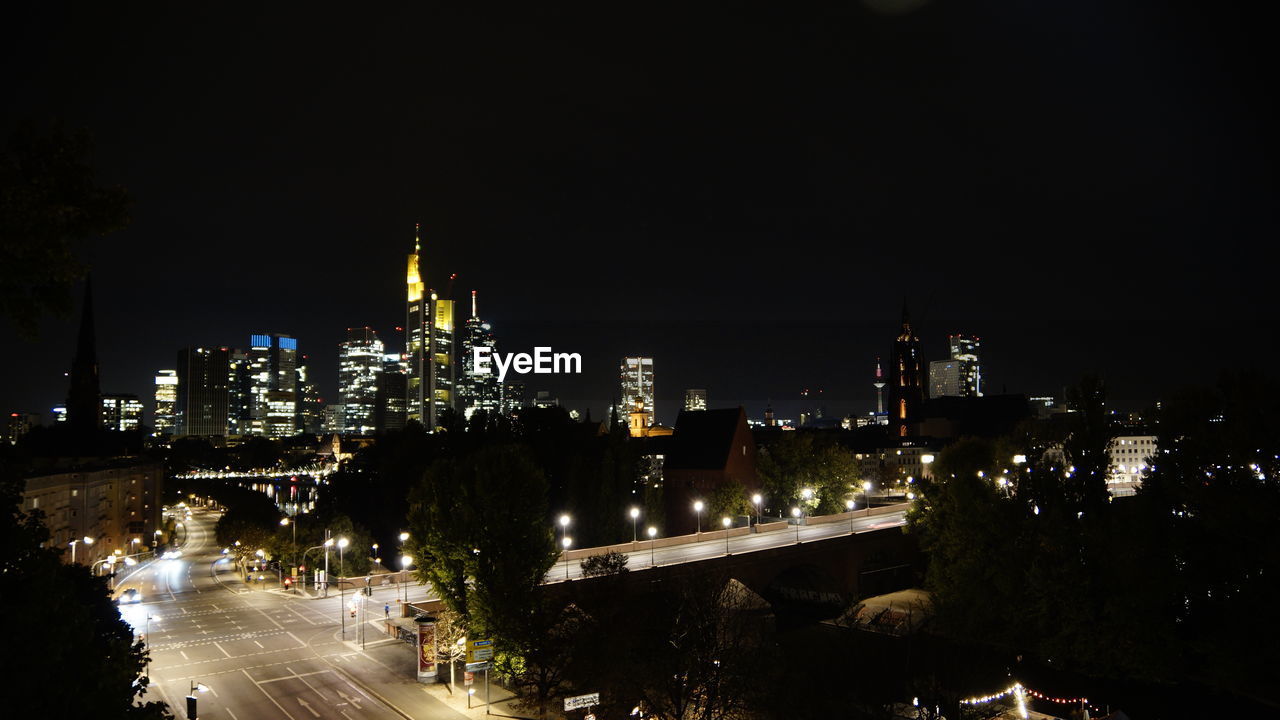 HIGH ANGLE VIEW OF ILLUMINATED CITY BUILDINGS