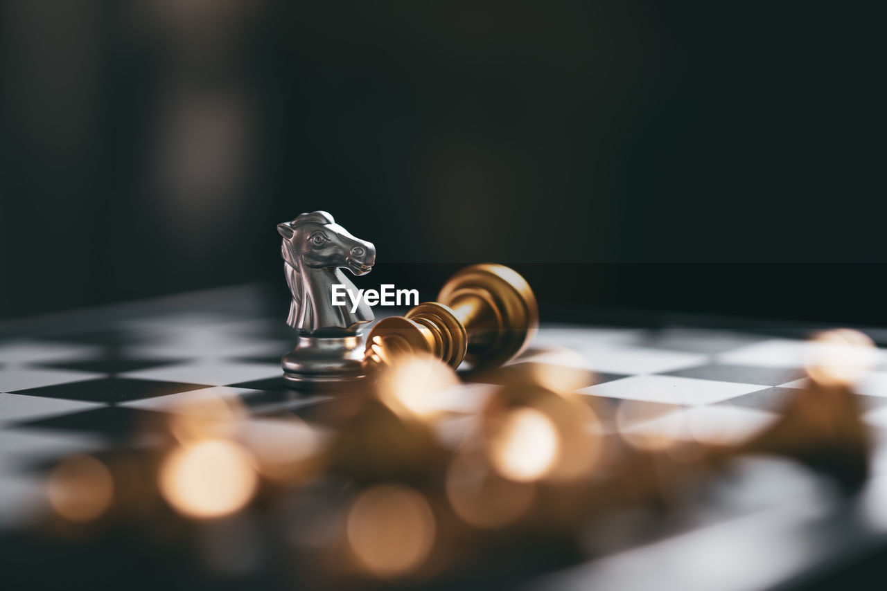 CLOSE-UP OF CHESS PIECES ON TABLE AT HOME