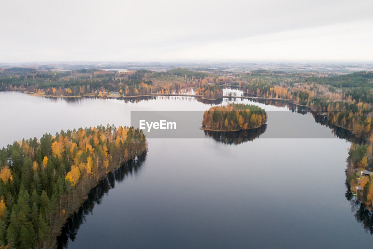 reflection, water, nature, lake, morning, sky, scenics - nature, architecture, no people, tranquility, beauty in nature, landscape, reservoir, environment, built structure, travel destinations, aerial photography, tree, outdoors, tranquil scene, plant, day, building exterior, travel, building, city, body of water, mountain, tourism