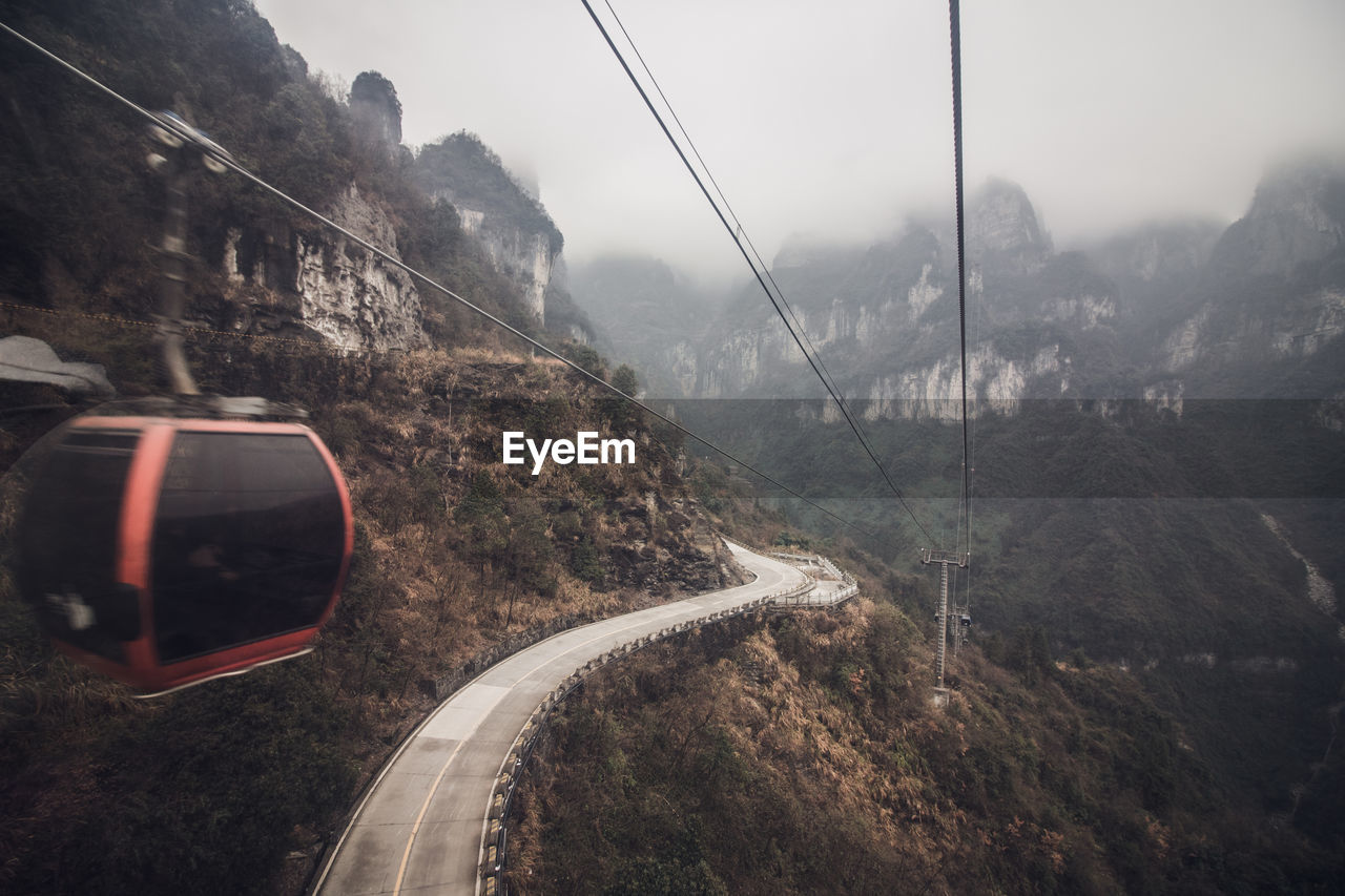 Overhead cable car above mountain road