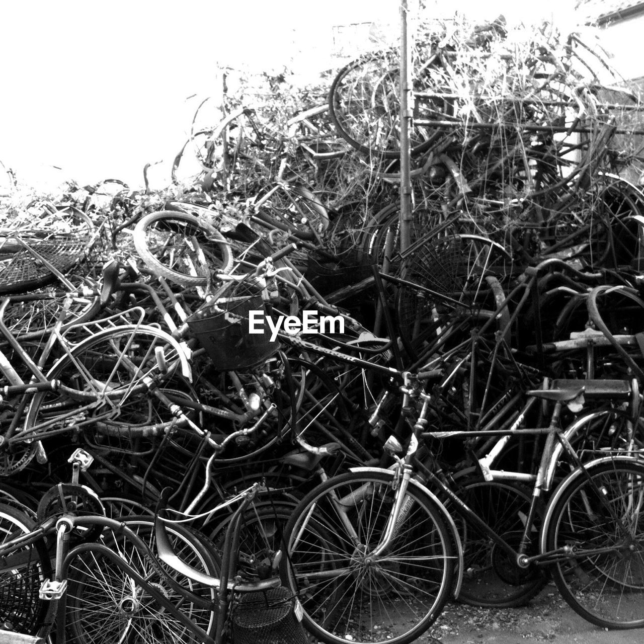 Stack of abandoned bicycles at junkyard