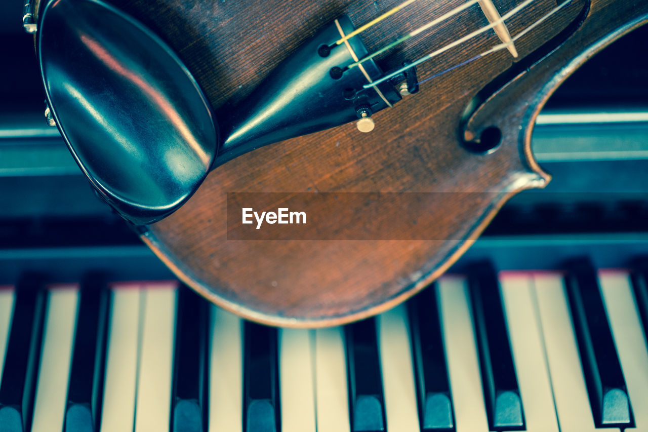 Close-up of violin on piano keys
