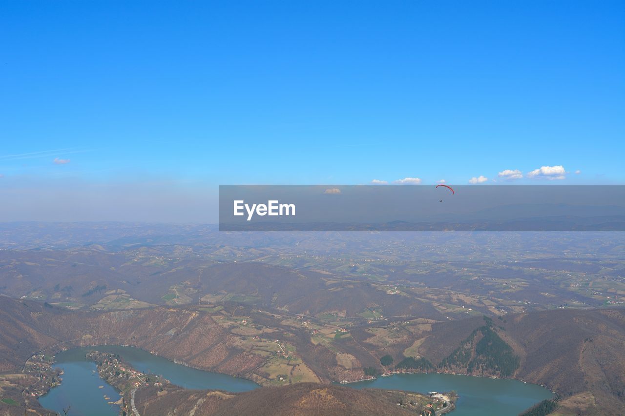 AERIAL VIEW OF CITYSCAPE AGAINST BLUE SKY