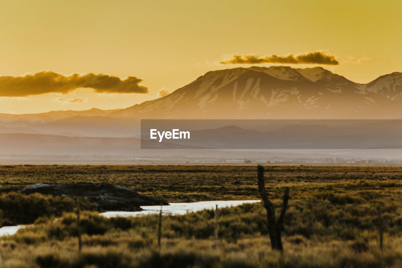 Scenic view of landscape against sky during sunset