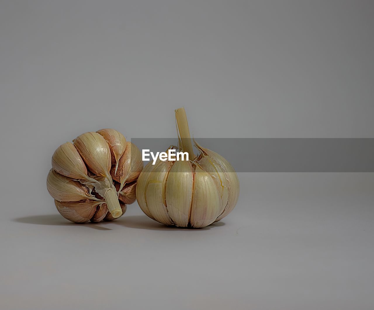 Close-up of garlic bulbs on white background