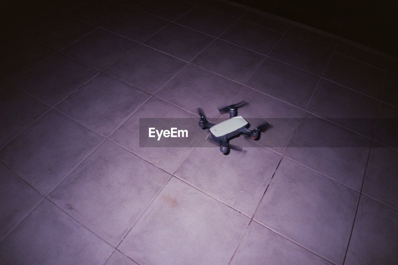 HIGH ANGLE VIEW OF PERSON WALKING ON AIRPORT