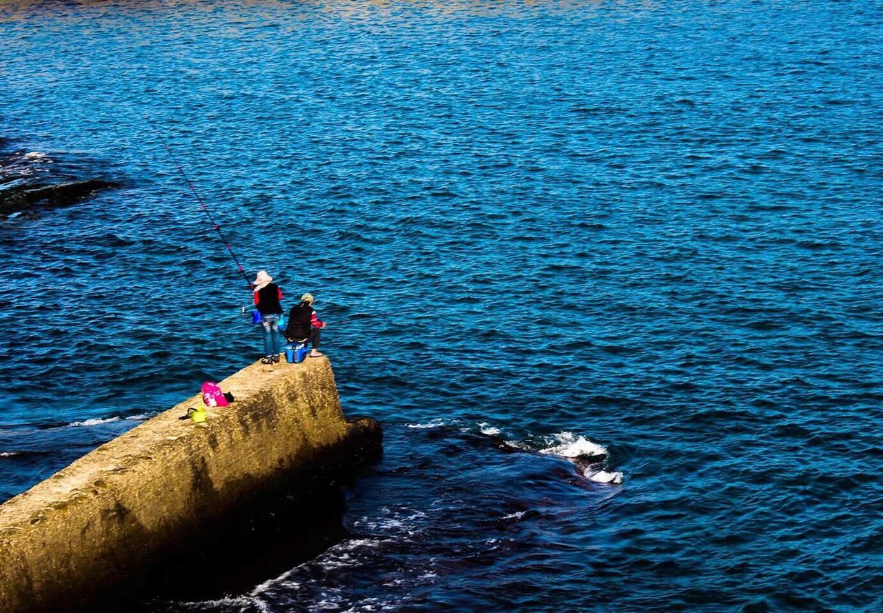 Women fishing in sea