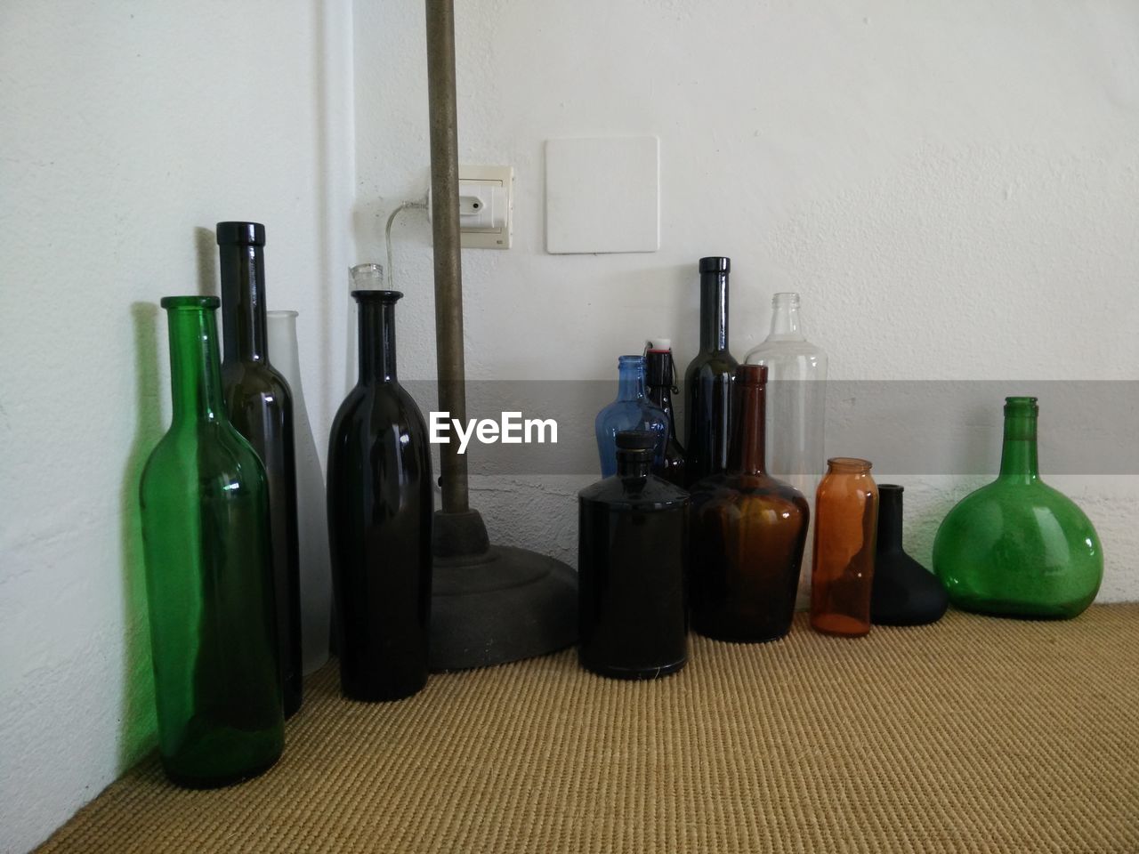 CLOSE-UP OF WINE BOTTLES ON TABLE