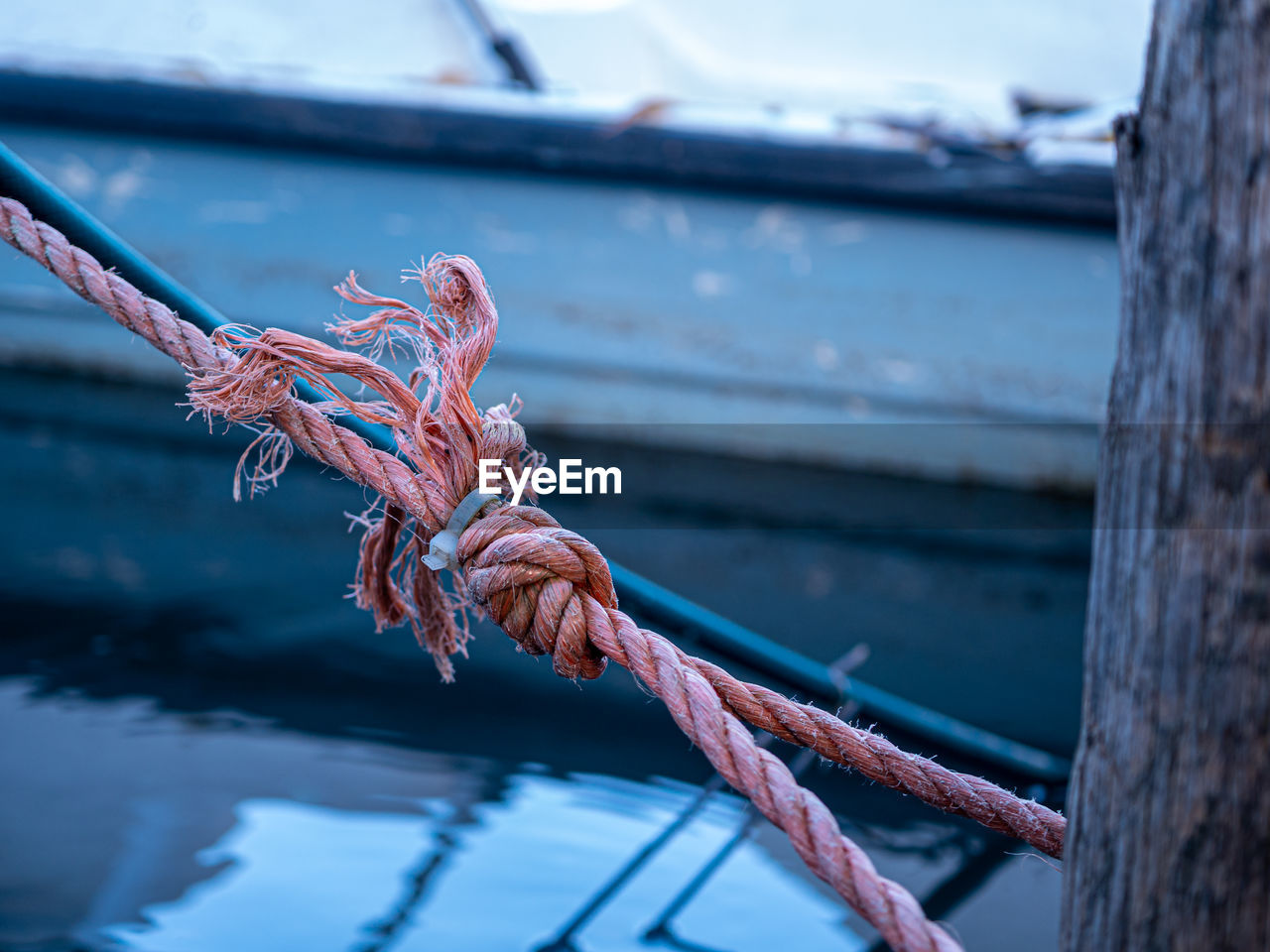 Close-up of rope tied to bollard