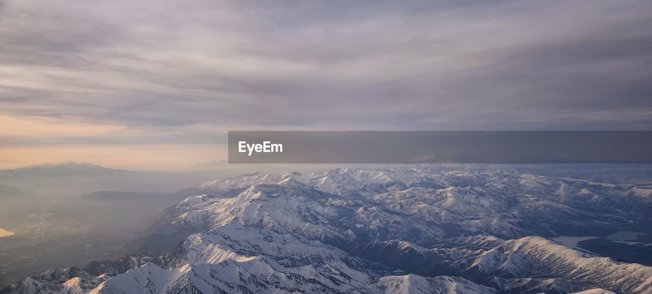 Aerial view of snowcapped mountains against sky