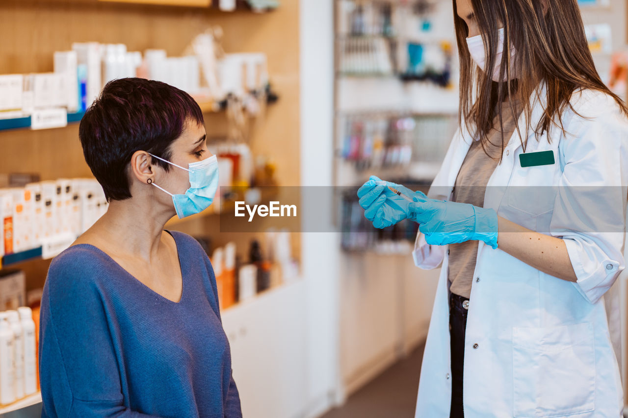 Woman taking vaccination at hospital