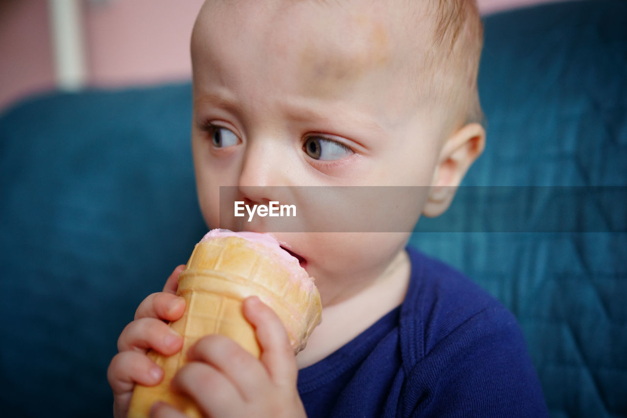 Child eats pink ice cream