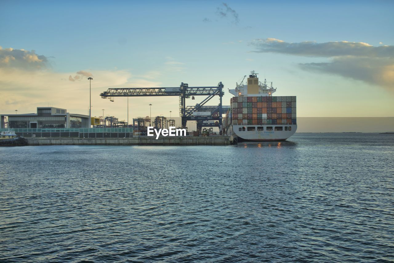 Cargo ship with a scenic view of sea against sky