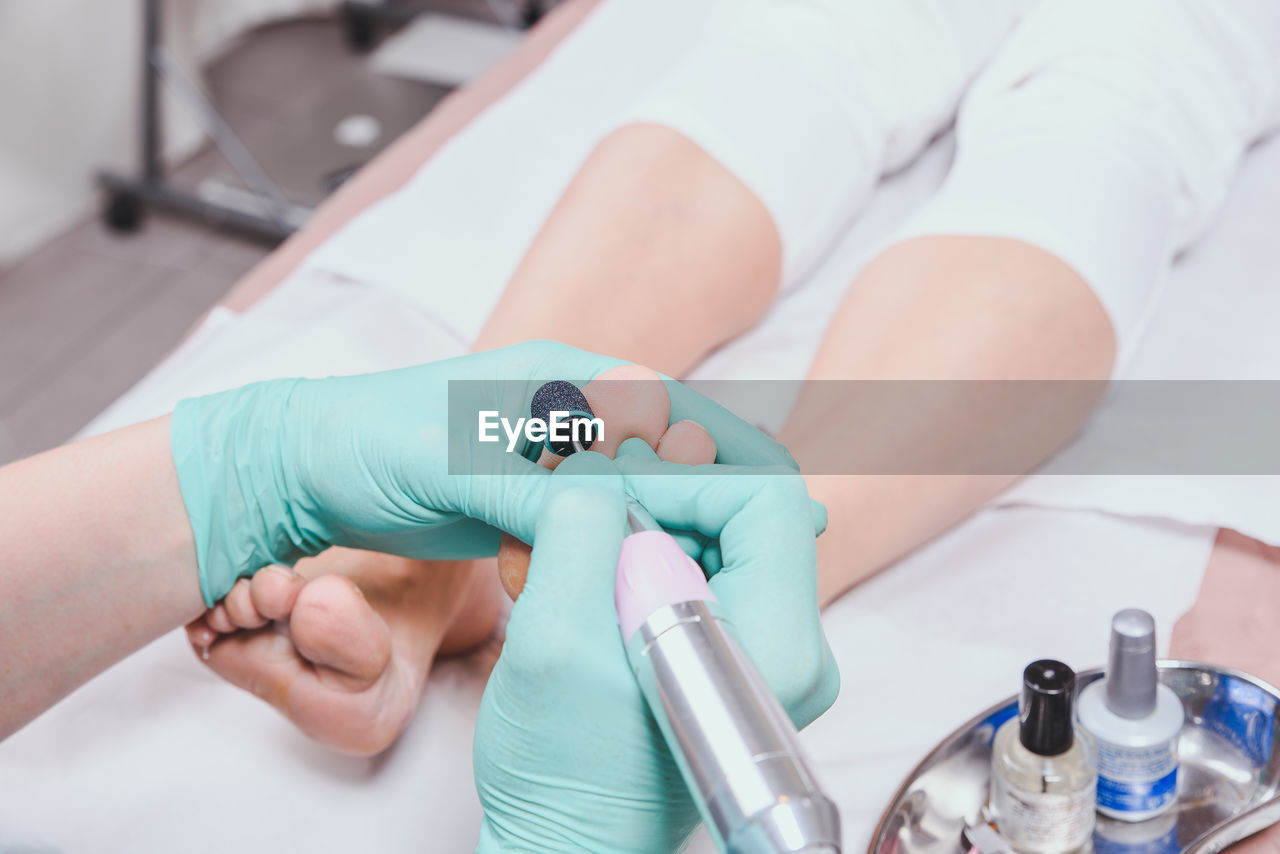 Cropped image of chiropodist with patient in clinic