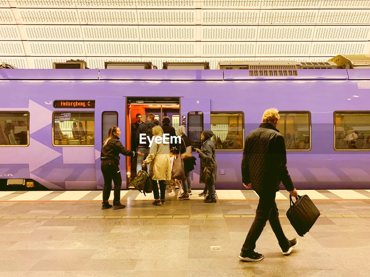 PEOPLE WALKING ON RAILROAD STATION