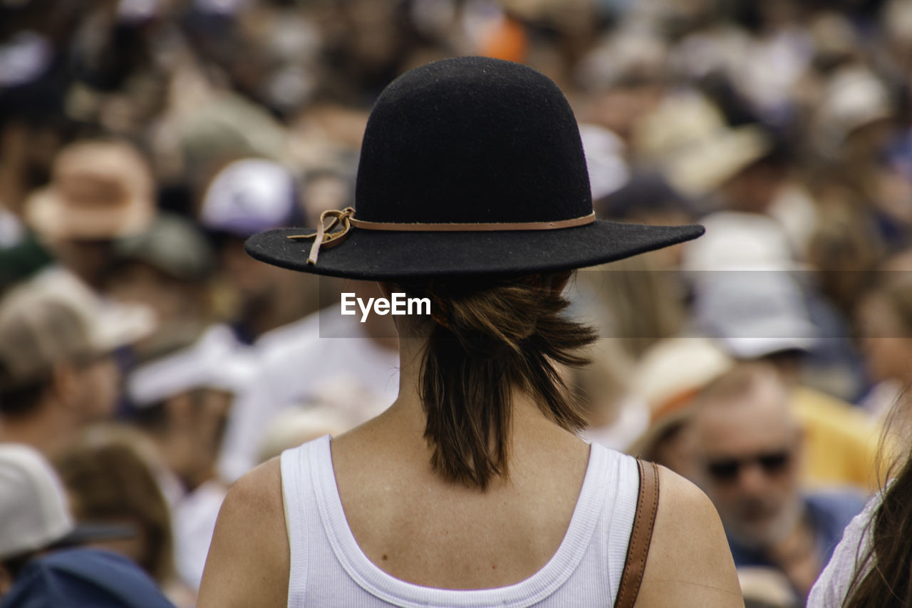 side view of woman wearing hat standing outdoors