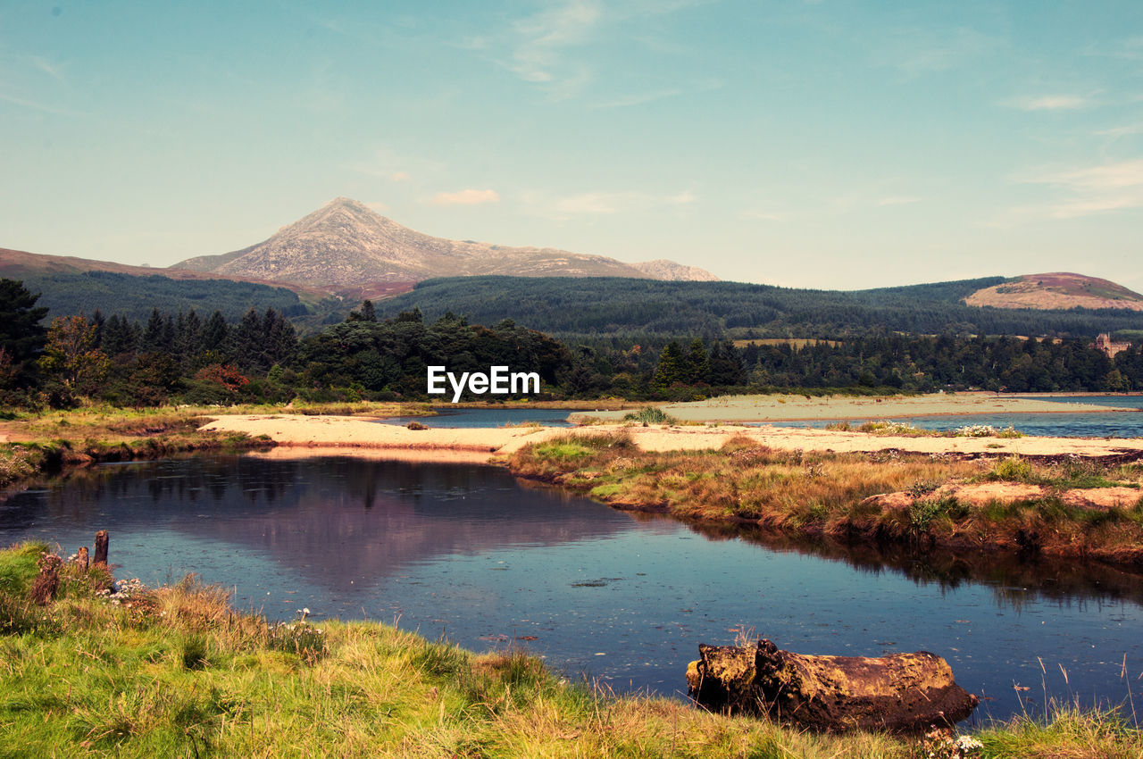 Scenic view of lake with goat fell mountain in background