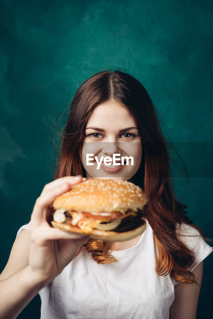 cropped hand of woman holding food