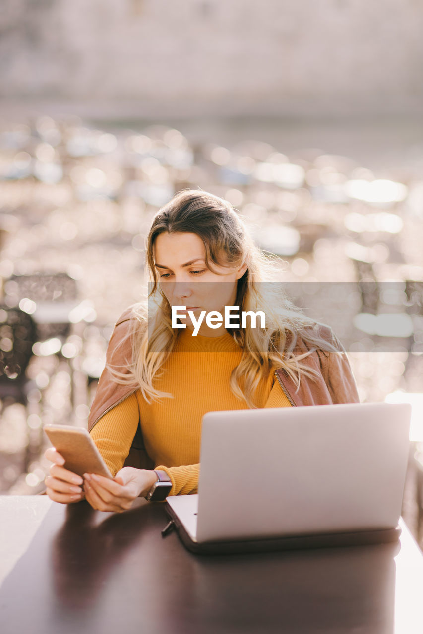 young woman using laptop on table