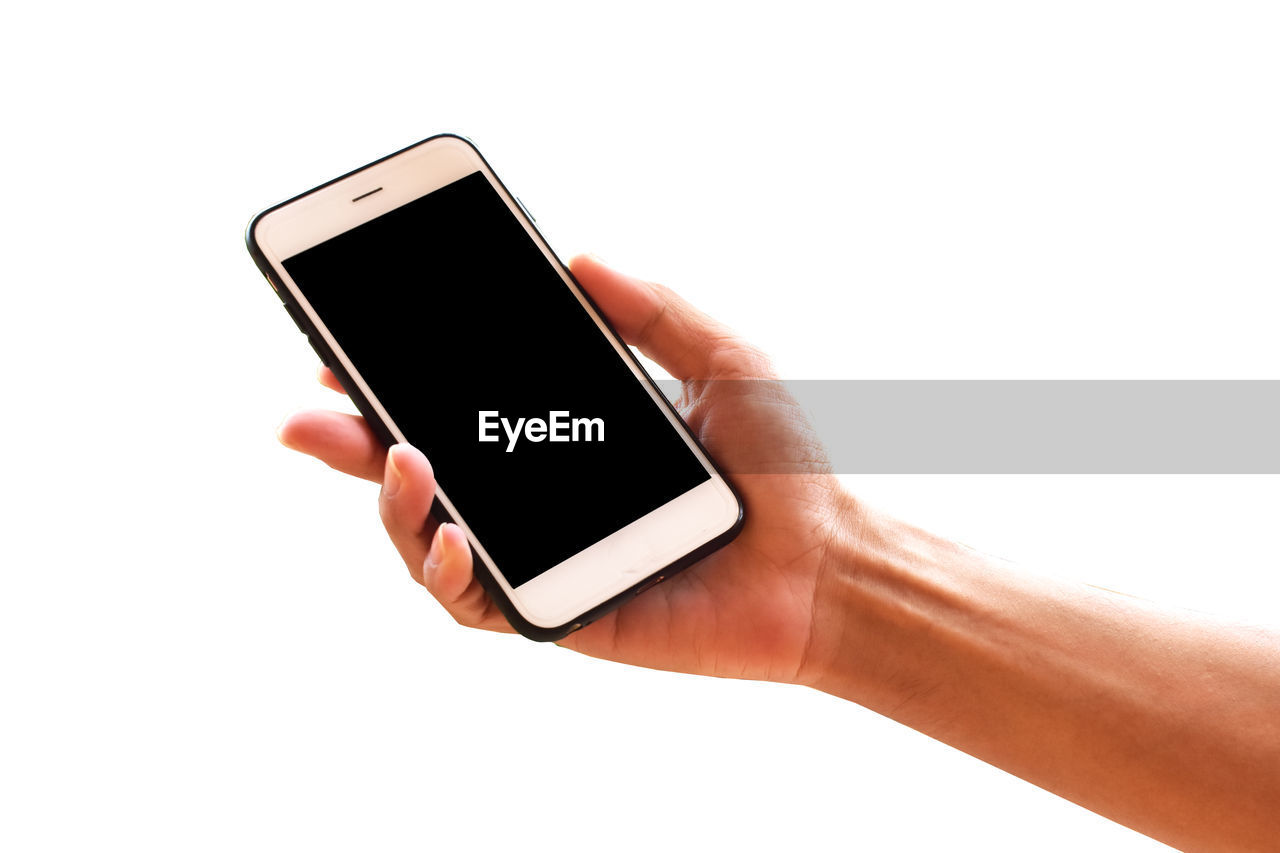 Cropped hand holding smart phone over white background