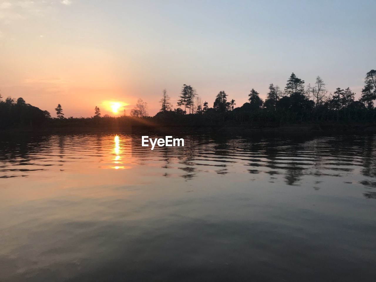 SCENIC VIEW OF LAKE AGAINST ORANGE SKY