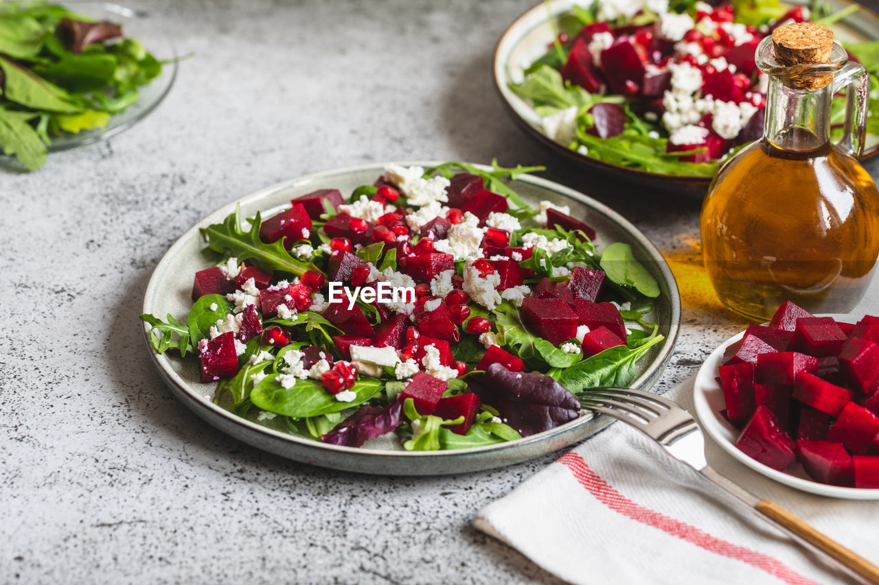 Arugula, beet and cheese salad with pomegranate and dressing 