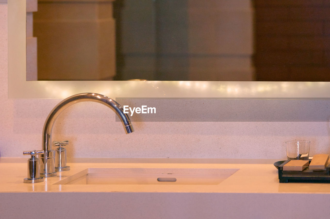 Close-up of faucet in bathroom at home