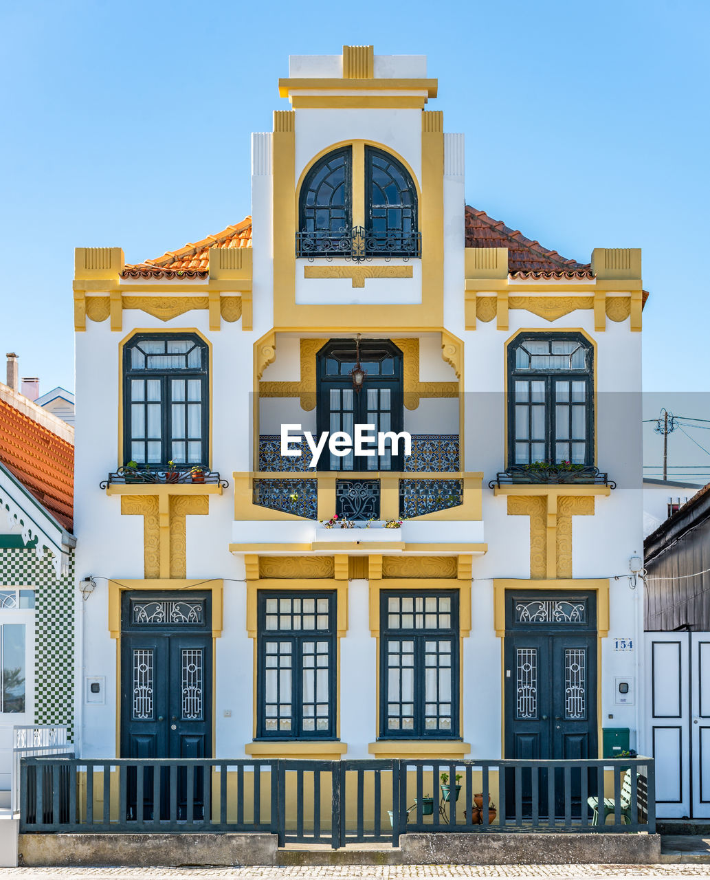 LOW ANGLE VIEW OF YELLOW BUILDING AGAINST SKY