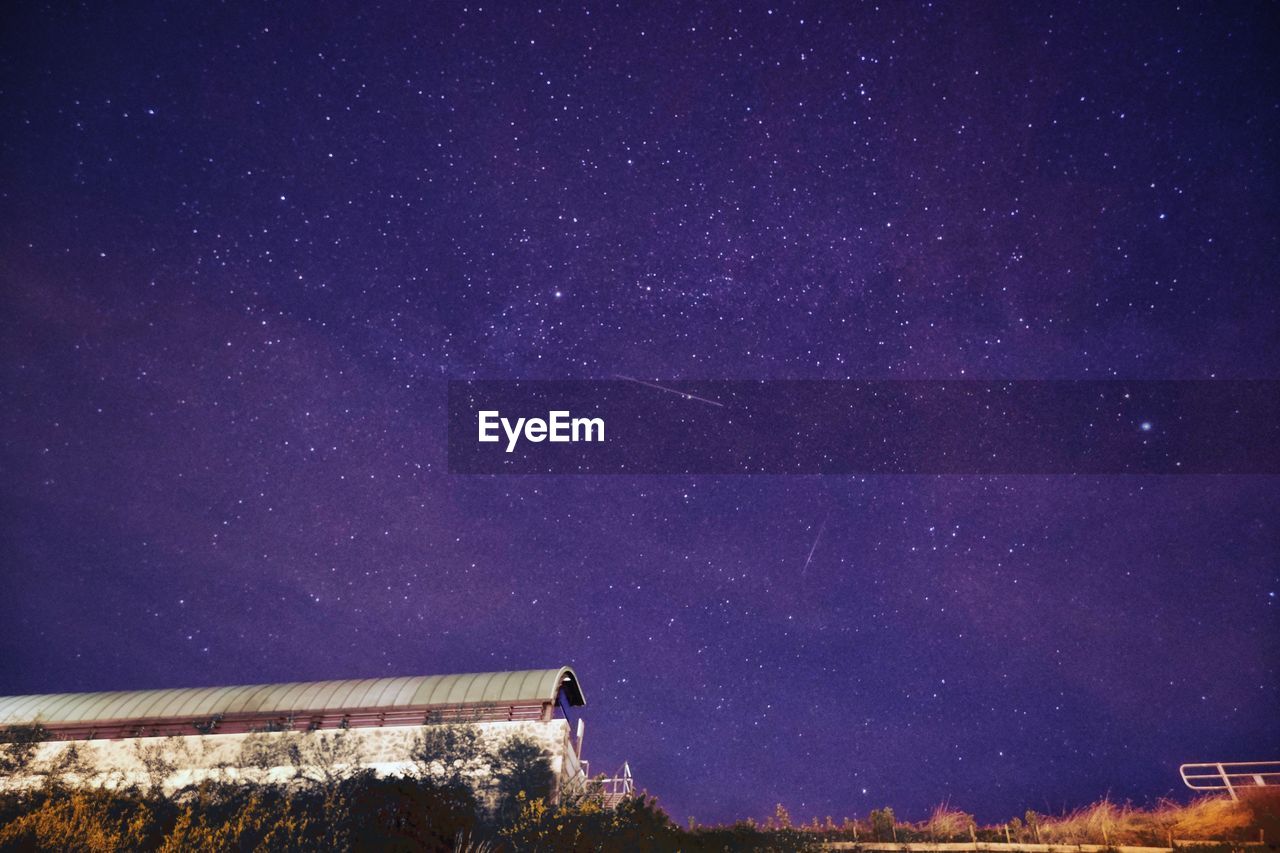 LOW ANGLE VIEW OF STARS AGAINST STAR FIELD AT NIGHT