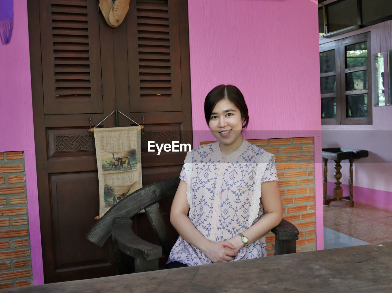 Portrait of smiling woman sitting on chair