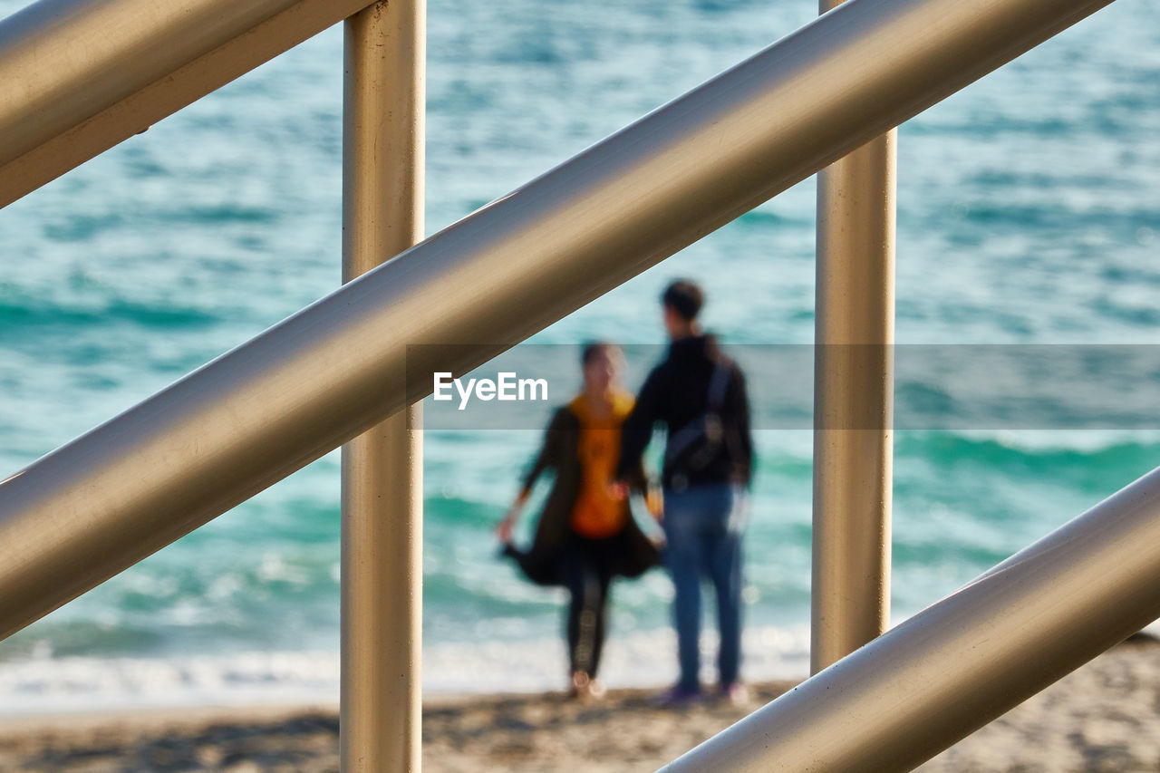 Couple standing by the sea against sea