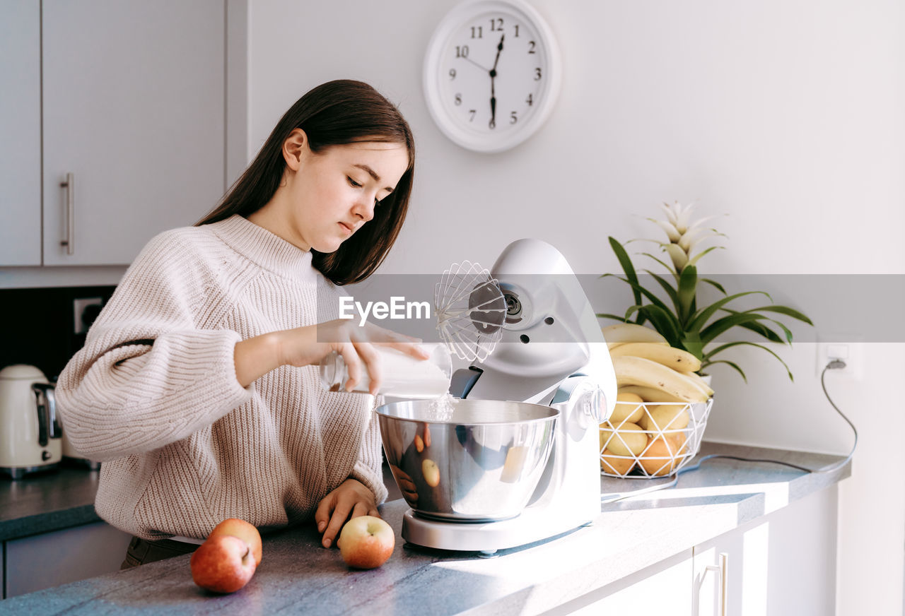 Cute girl preparing food at home