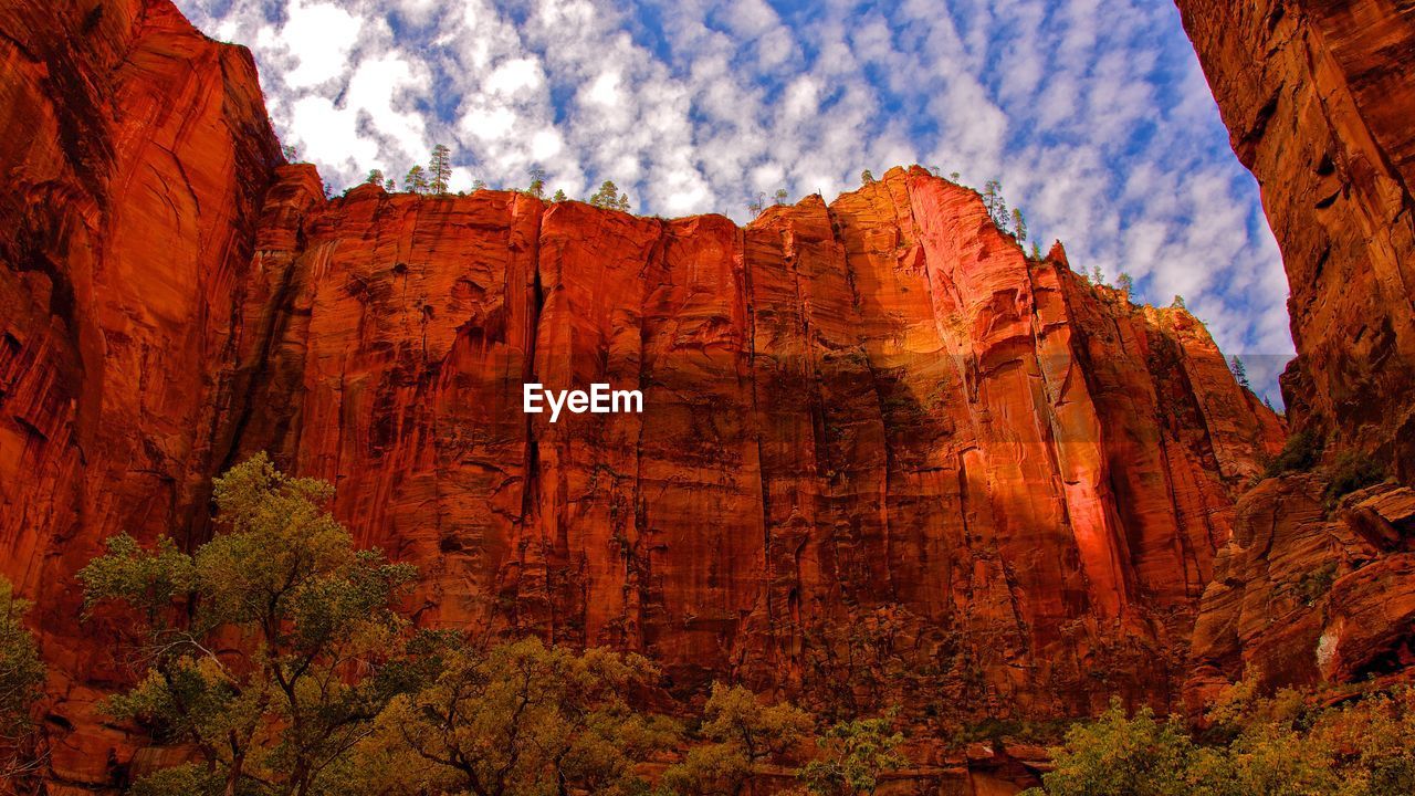 Low angle view of rock formation against cloudy sky