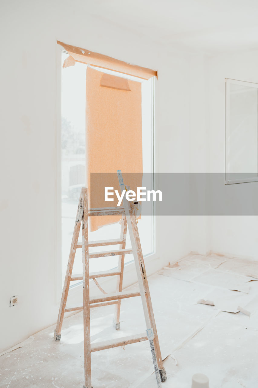 Ladder on white room at construction site. painting walls. home improvement, renovation