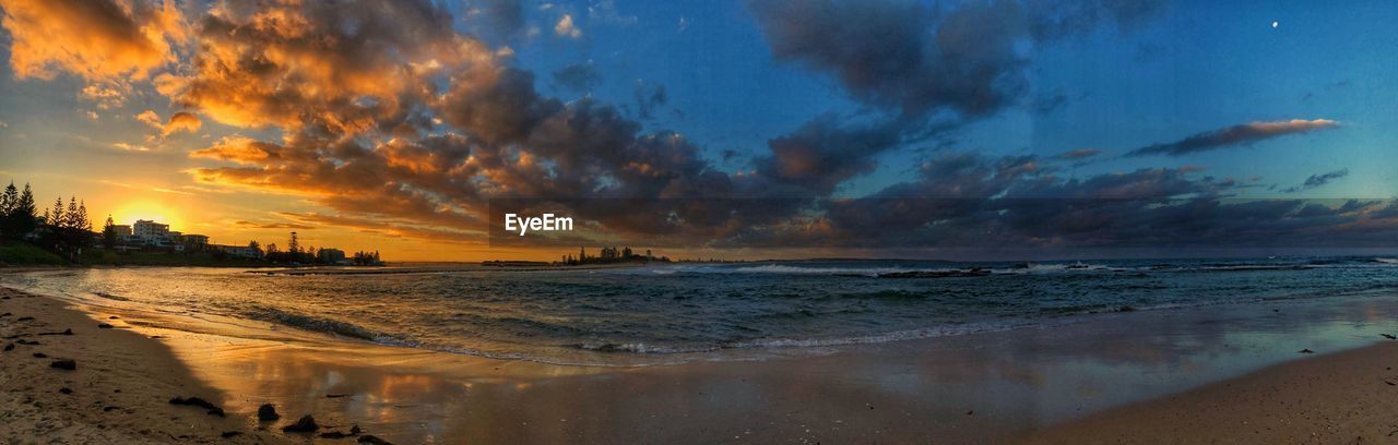 Panoramic view of beach against sky during sunset