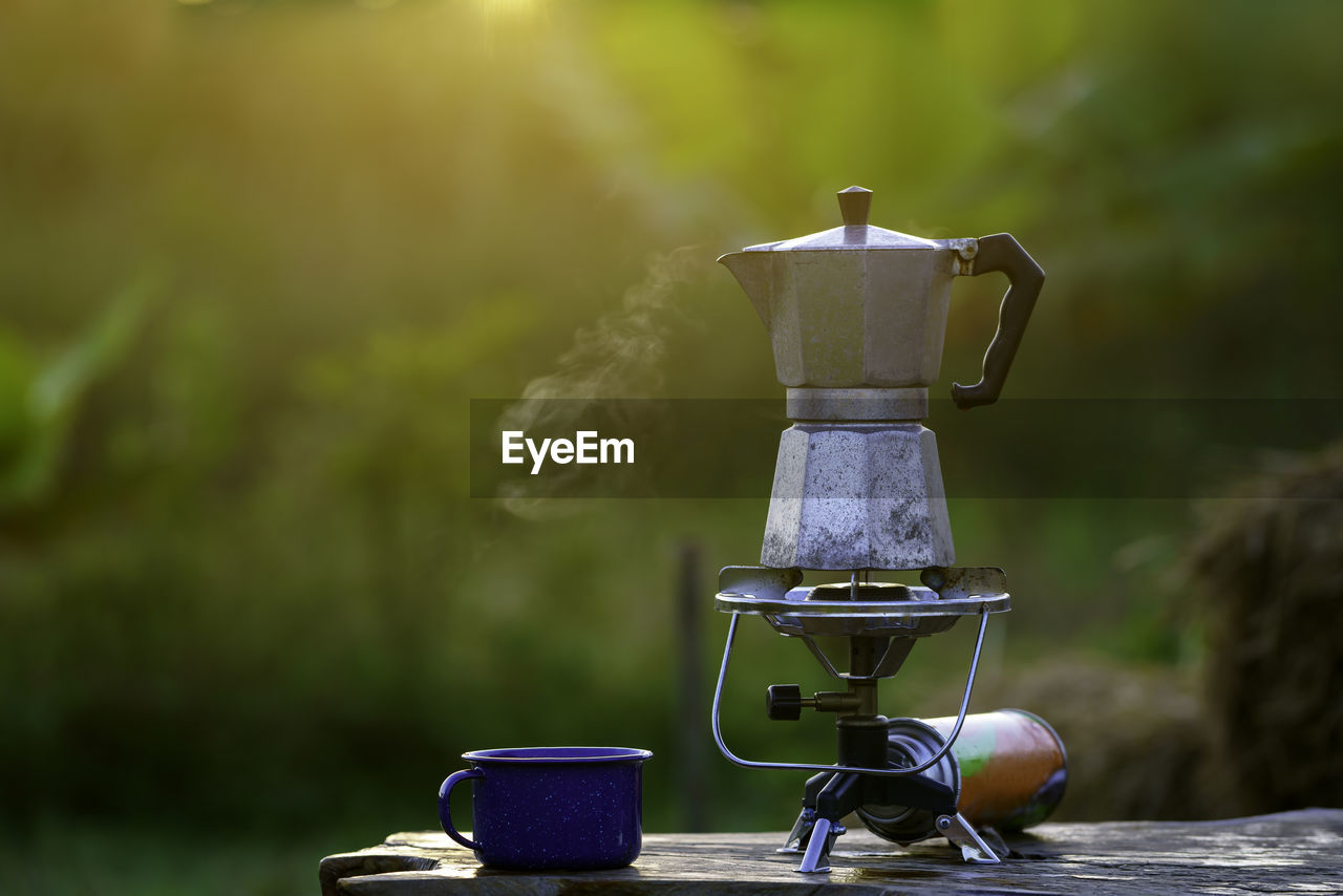 Antique coffee pot on the gas stove for camping when the sun rises in the morning.