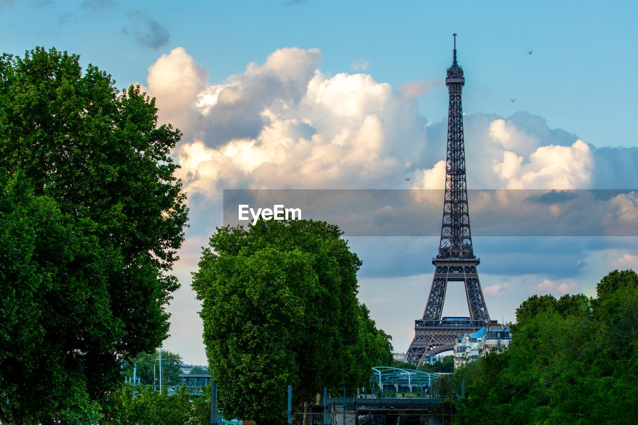 Eiffel tower against cloudy sky