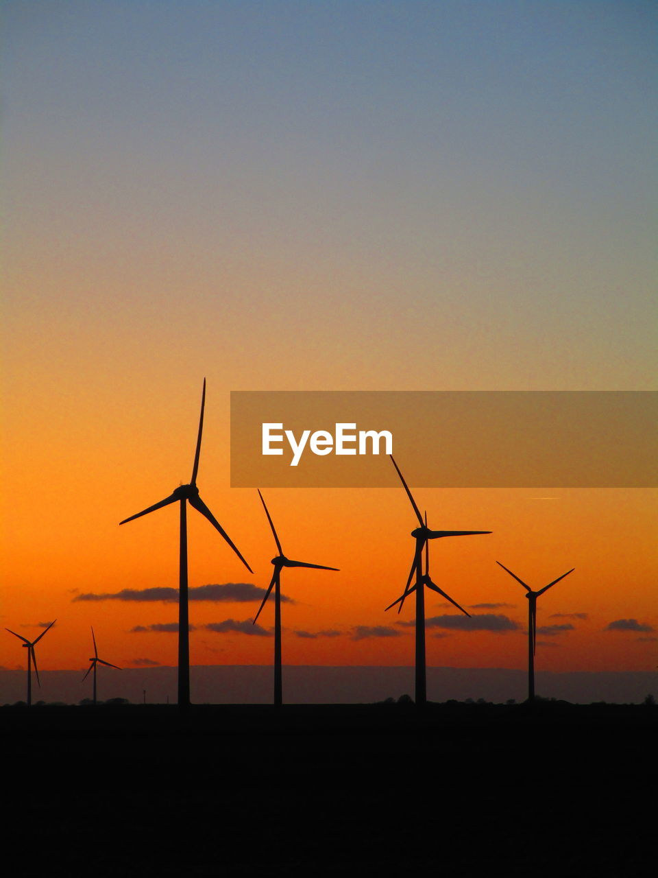 SILHOUETTE WINDMILL ON FIELD AGAINST SKY AT SUNSET