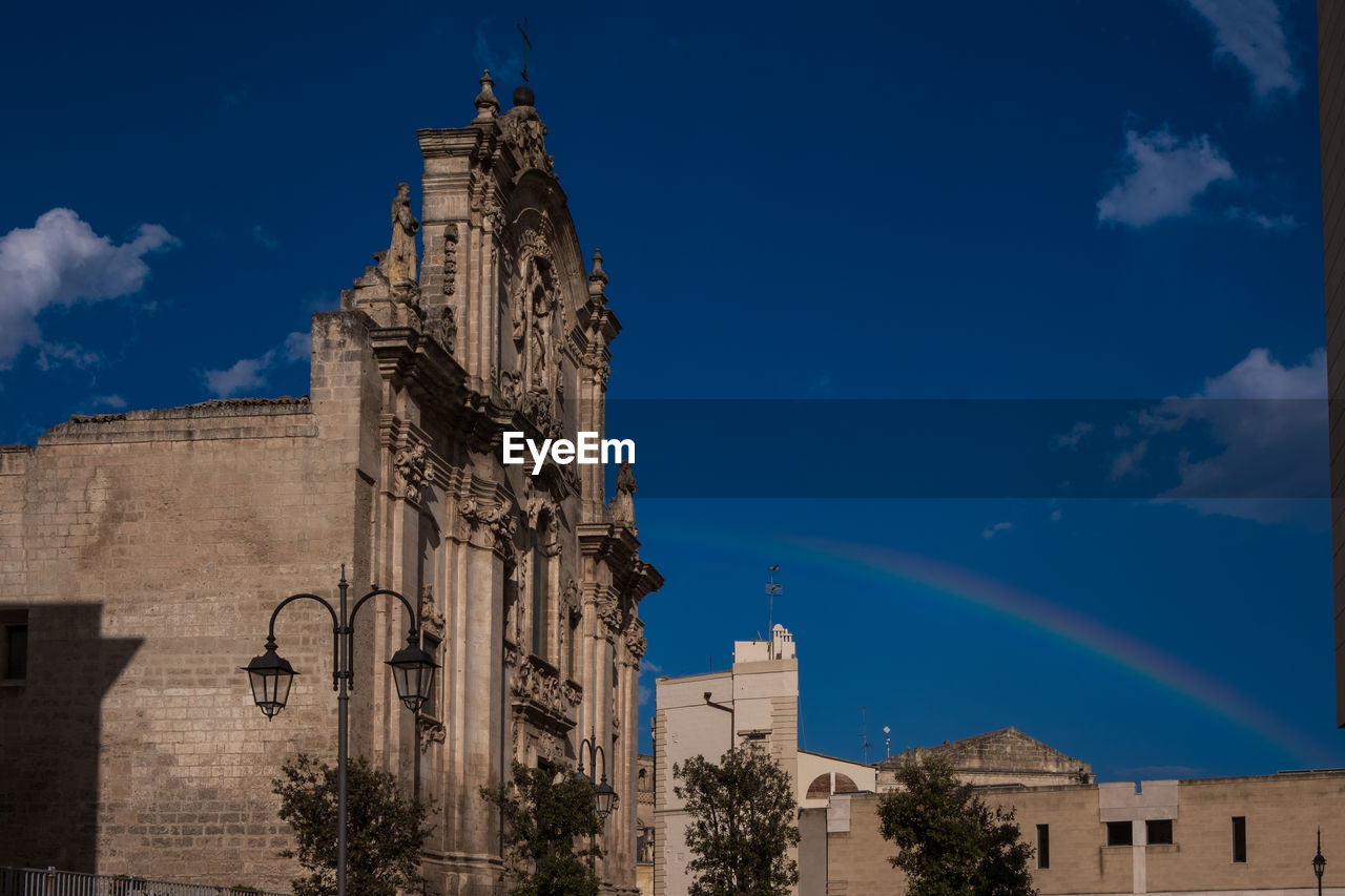 architecture, building exterior, built structure, sky, building, travel destinations, history, the past, nature, place of worship, landmark, religion, blue, city, tower, cloud, belief, travel, tree, spirituality, no people, low angle view, tourism, outdoors, worship, rainbow, plant, old, catholicism, cityscape, night