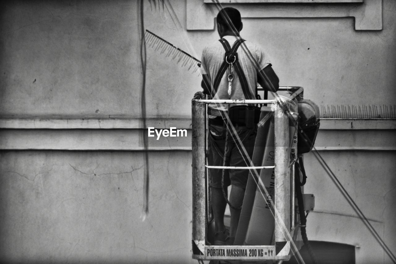 MAN STANDING ON BUILDING