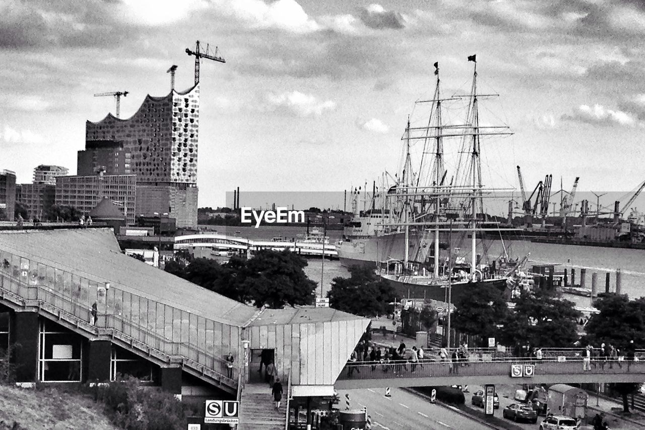 VIEW OF HARBOR AGAINST CLOUDY SKY