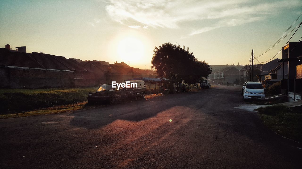 Cars parked on roadside against sky