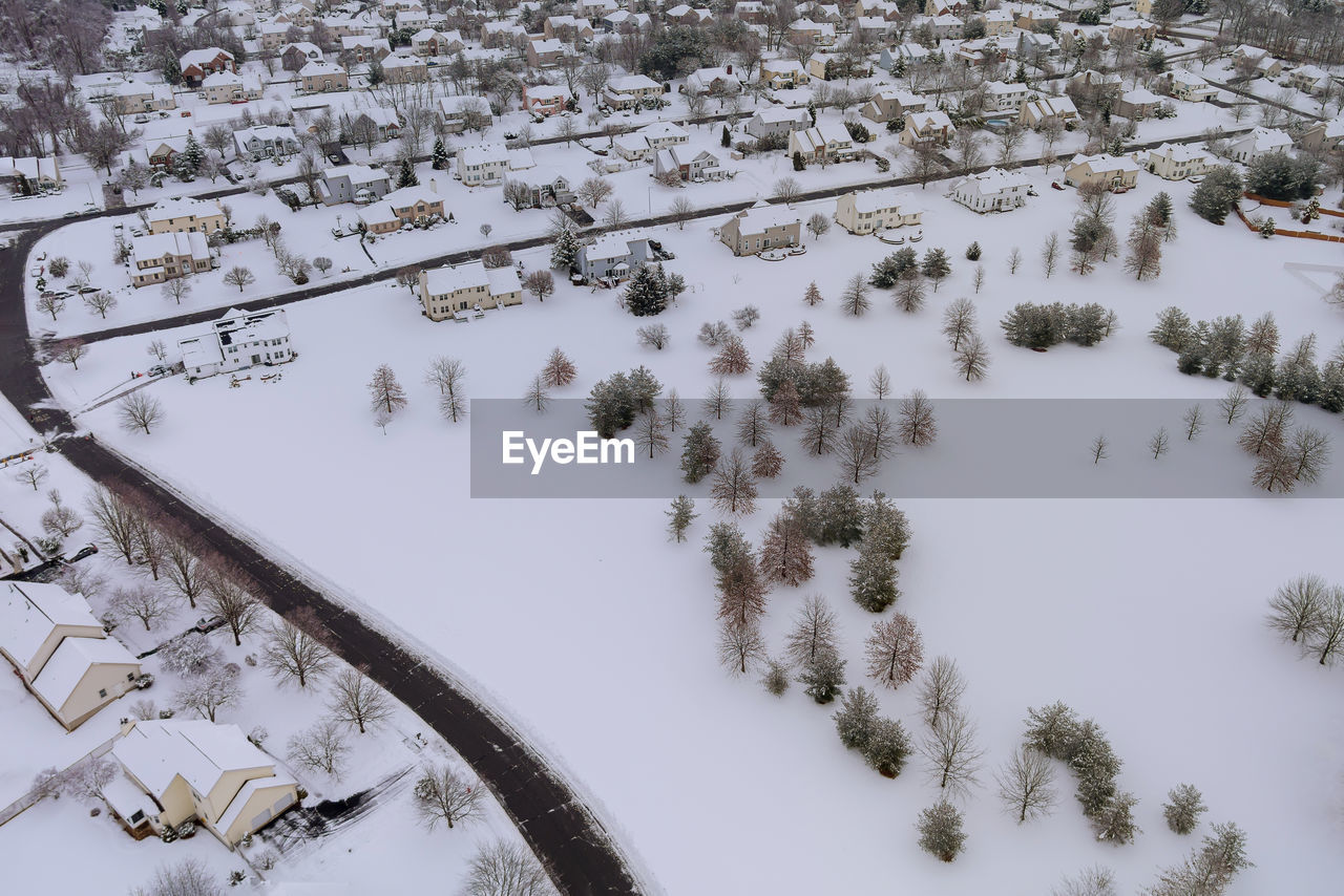 HIGH ANGLE VIEW OF SNOW COVERED TREES AND PLANTS ON FIELD