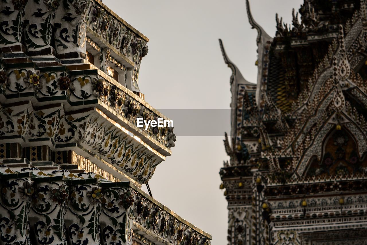 LOW ANGLE VIEW OF TEMPLE AGAINST BUILDING