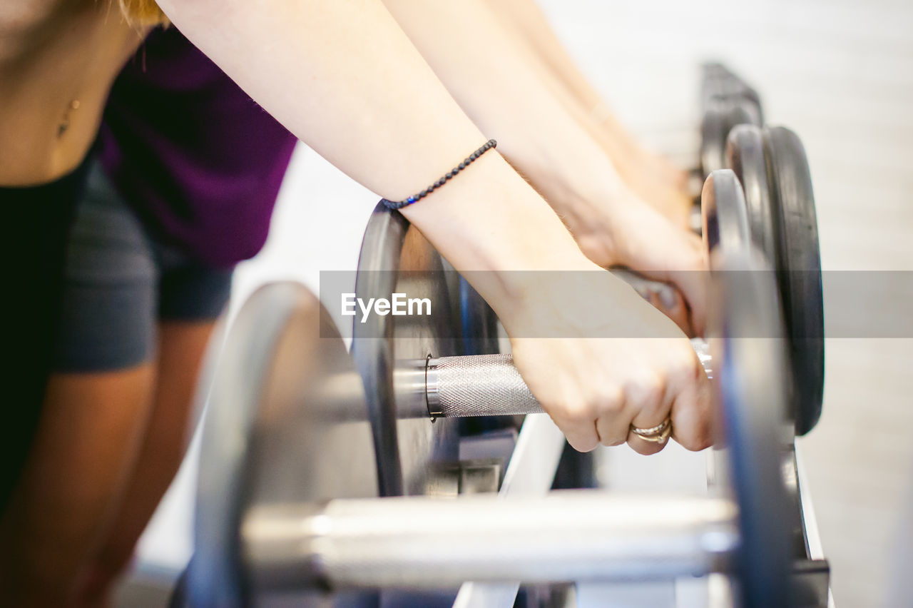 Midsection of women exercising in gym