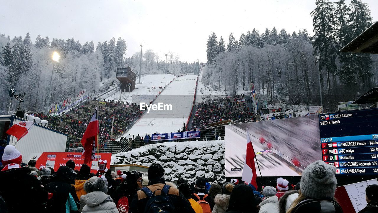 Rear view of people watching ski jumping competition